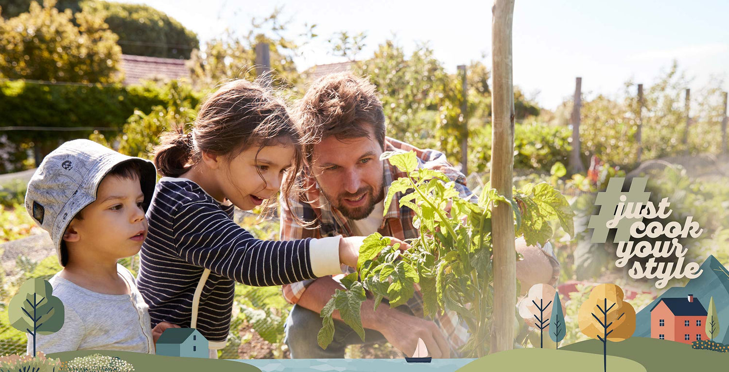 Vater mit Kindern beim Gärtnern im Gemüsegarten – natürliche Lebensmittel, gemeinsame Zeit und bewusste Ernährung
